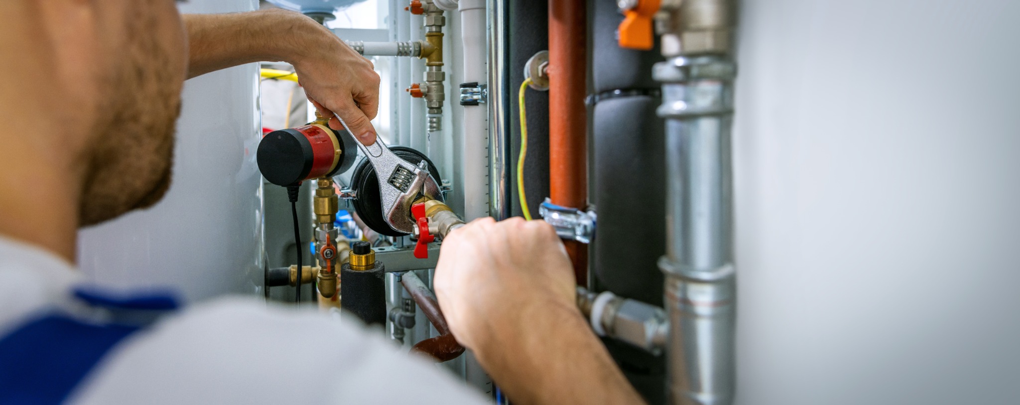 Plumber working on pipes