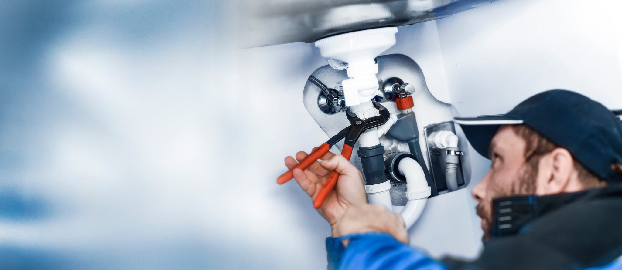 Plumber installing fixtures